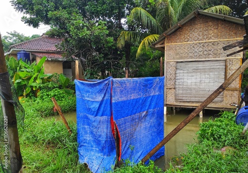 Local houses in the village with ornaments made of bamboo, traditional bathrooms. Next to the house there are coconut trees,and around it there are traditional fish farms.Buildings and natural scenery