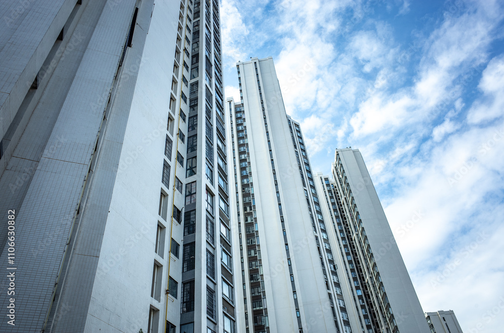 Looking up of multiple high-rise residential apartment buildings with numerous floors in China. Concept of housing market, real estate, homes, high-density neighborhood. Looking up of multiple high-rise residential apartment buildings with numerous floors in China. Concept of housing market, real estate, homes, high-density neighborhood.