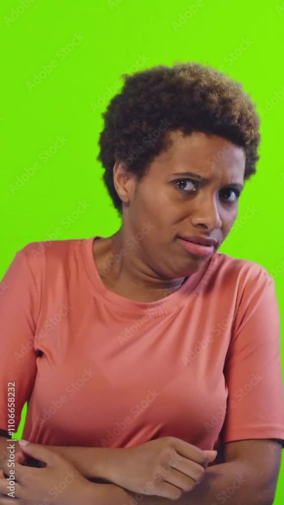 Young woman with curly hair displays a shocked expression, hands raised in disbelief. Set against a bright green background, her vibrant energy captures the unexpected moment. Young woman with curly hair displays a shocked expression, hands raised in disbelief. Set against a bright green background, her vibrant energy captures the unexpected moment.