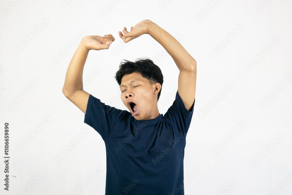 Asian man with a sleepy expression and yawning with messy hair. Wake up concept. Isolated on white background. Asian man with a sleepy expression and yawning with messy hair. Wake up concept. Isolated on white background.