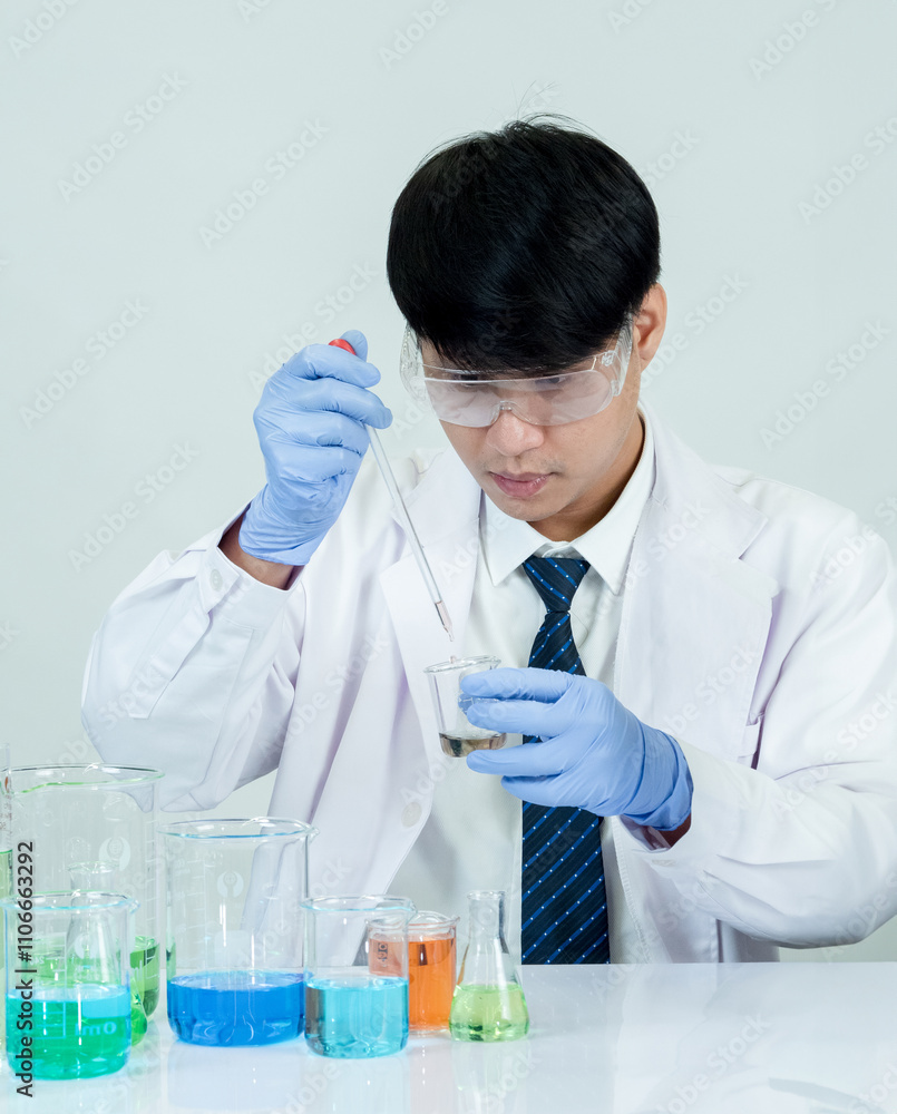 Portrait asian man student scientist or doctor look hand holding reagent mixing laboratory in science research laboratory with test tubes of various size in laboratory chemistry lab white background Portrait asian man student scientist or doctor look hand holding reagent mixing laboratory in science research laboratory with test tubes of various size in laboratory chemistry lab white background