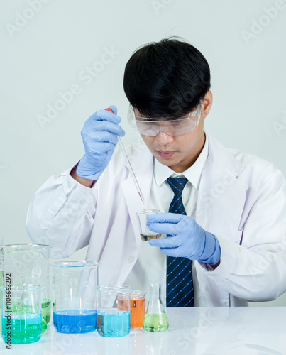 Portrait asian man student scientist or doctor look hand holding reagent mixing laboratory in science research laboratory with test tubes of various size in laboratory chemistry lab white background