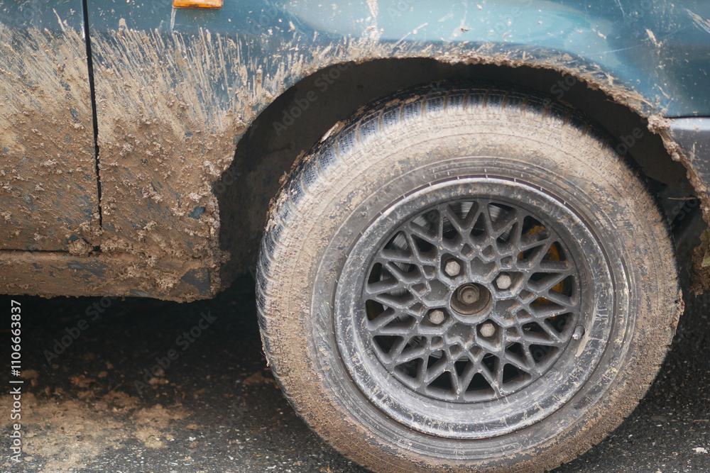 CloseUp Capture of a MudCovered Tire on a Vintage Classic Cars Exterior Surface CloseUp Capture of a MudCovered Tire on a Vintage Classic Cars Exterior Surface