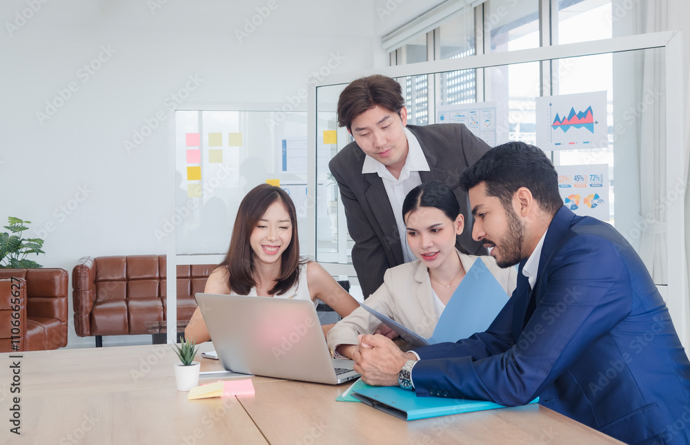 Business team woman and man asian group meeting sitting on desk looking talk think creative idea computer on table ready happy working new project job online product sale marketing in office company. Business team woman and man asian group meeting sitting on desk looking talk think creative idea computer on table ready happy working new project job online product sale marketing in office company.