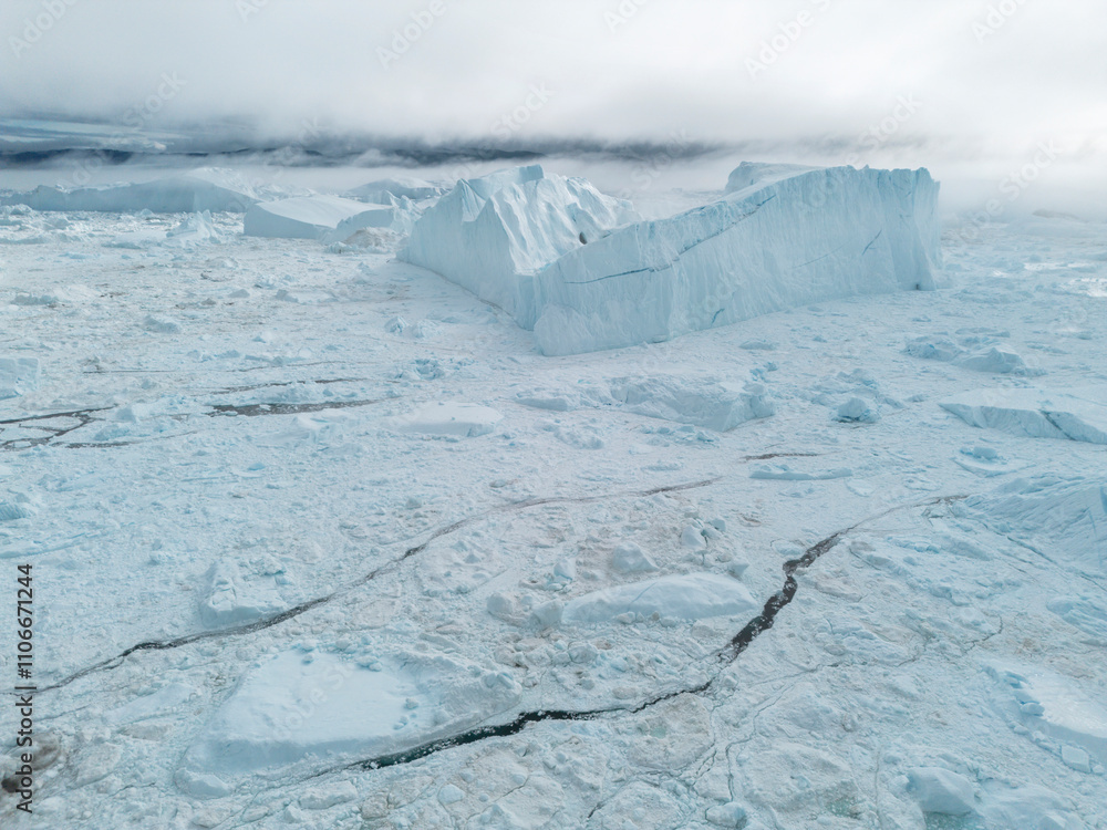 Obraz premium Drone shot of huge iceberg floating and melting, Jakobshavn Glacier, Ilulissat, Greenland