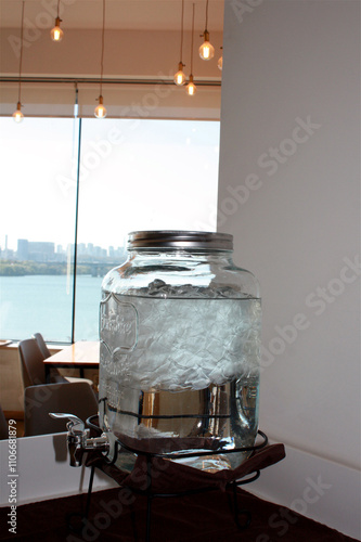 A dispenser with drinking water in a cafe
