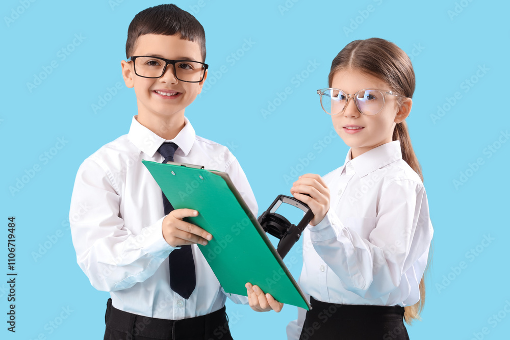 Little business colleagues stamping document on blue background. Opposite Day celebration Little business colleagues stamping document on blue background. Opposite Day celebration