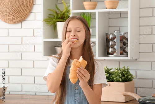 Cute little happy girl eati...