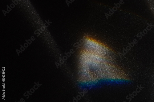 Rainbow sun flares on black background, colorful glare and shine, light rays on sparkling surface. Rainbow refraction of bright sunlight on dark fon. Natural light effects, trend aesthetic