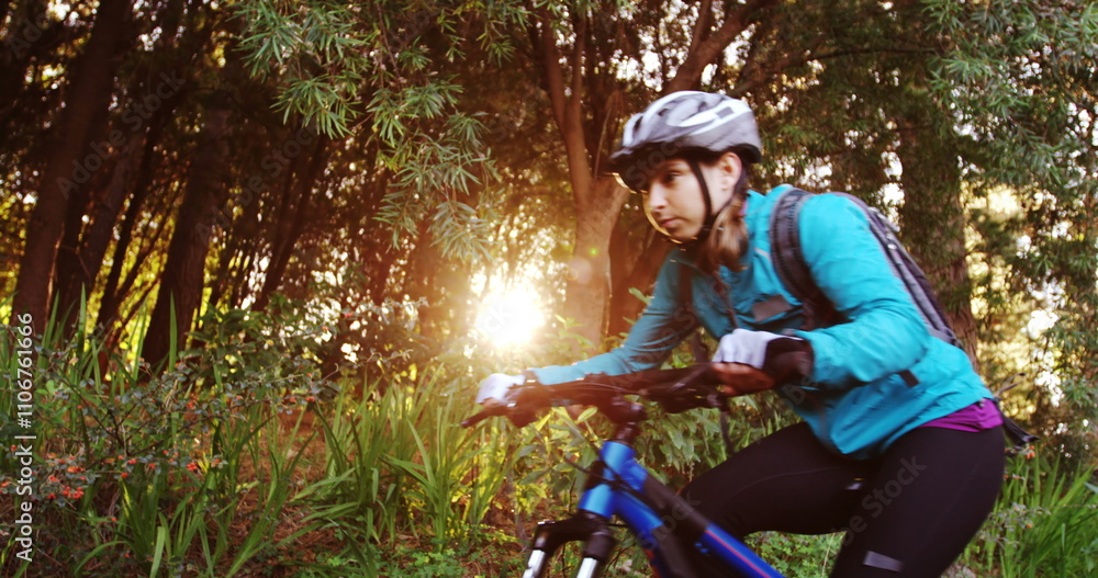 Female mountain biker riding in the forest on a sunny day 4k Female mountain biker riding in the forest on a sunny day 4k