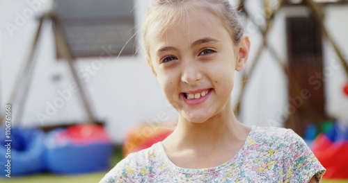 Portrait of happy girl holding egg and spoon in backyard 4k photo