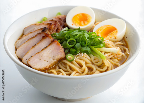 Close-up of a bowl of steaming ramen noodles with sliced pork, boiled egg, and green onions, arranged beautifully on a white porcelain bowl against a plain white background.