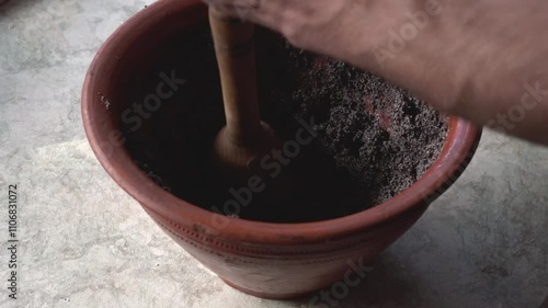 Grinding festive dish in a clay pot