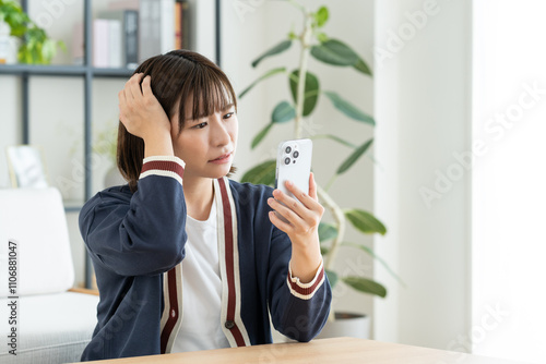 スマホで悩む若い女性 photo