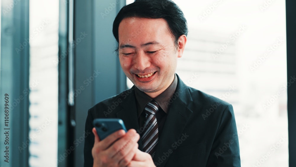 Man, phone and happy at window for business, research economy and good news in Japanese company. Finance investor, tech and reading in office for report, stock market update or investment opportunity Man, phone and happy at window for business, research economy and good news in Japanese company. Finance investor, tech and reading in office for report, stock market update or investment opportunity