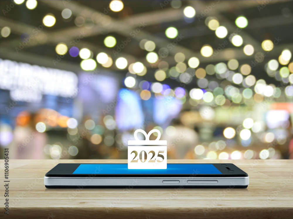Gift box happy new year 2025 icon on modern smart mobile phone screen on wooden table over blur light and shadow of shopping mall, Business happy new year 2025 shop online concept Gift box happy new year 2025 icon on modern smart mobile phone screen on wooden table over blur light and shadow of shopping mall, Business happy new year 2025 shop online concept