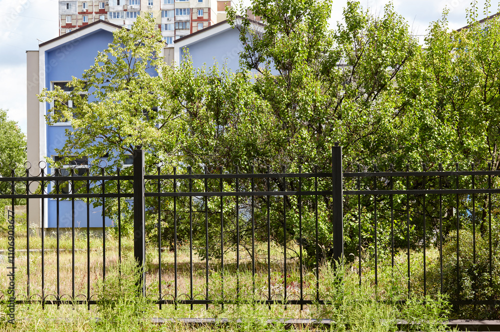 Metal fence in the city park. Decorative black iron guardrail for protection, close up Metal fence in the city park. Decorative black iron guardrail for protection, close up
