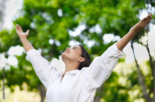 Relaxed happy refreshing young south asian woman taking a deep breath of clean unpolluted air in urban park, good summer, summer wellness, sunlight exposure concept image