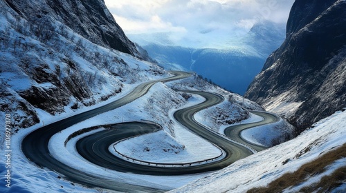 Scenic Snowy Mountain Road with Serpentine Curves and Dramatic Sky
