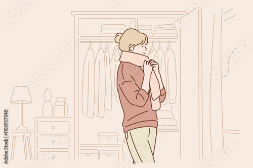 The woman puts on his scarf before going out. Hand drawn style vector design illustrations.