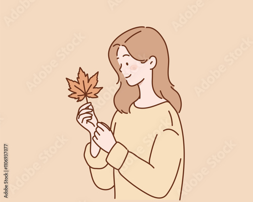young woman holding fallen leaf.
Hand drawn style vector design illustrations.