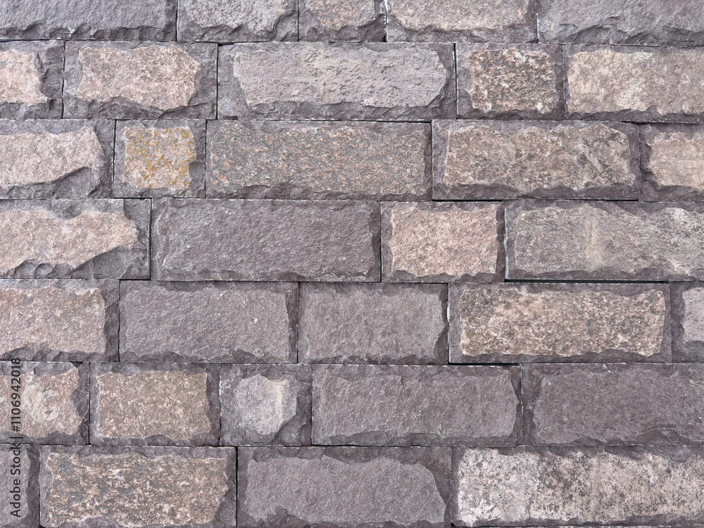 Fototapeta premium A brick wall with a gray and brown color