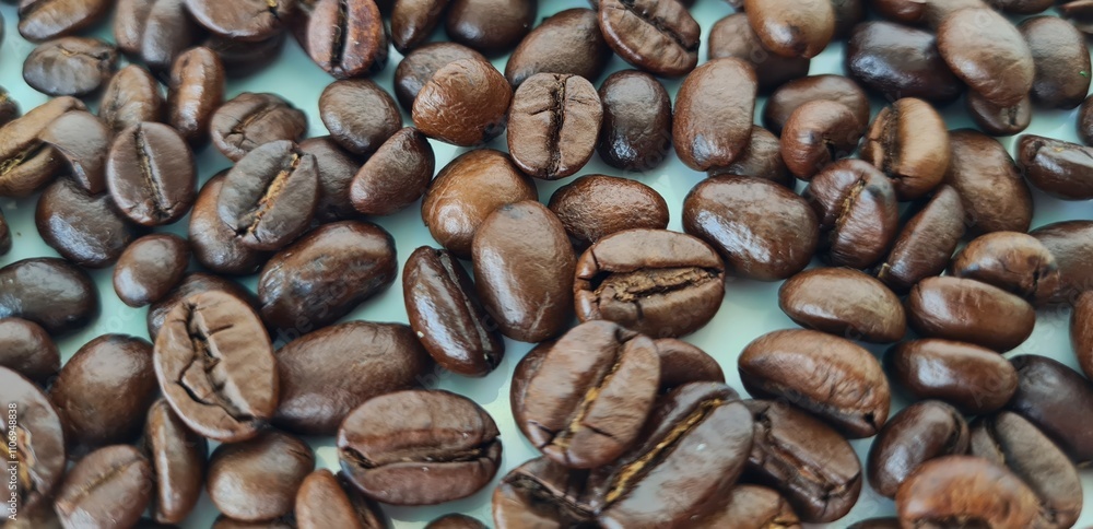 Closeup of fresh roasted coffee beans isolated on white background Closeup of fresh roasted coffee beans isolated on white background