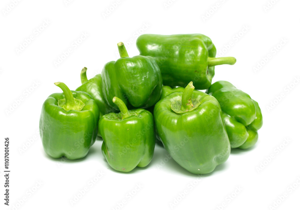 A bunch of green peppers are piled on top of each other A bunch of green peppers are piled on top of each other