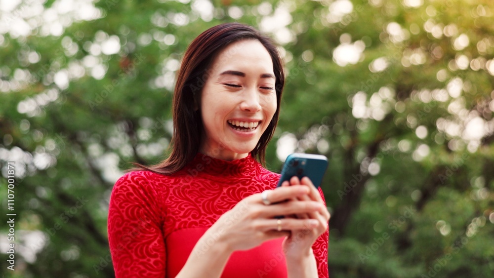 Woman, phone and texting at park, happy and laugh at funny meme, notification or chat on mobile app in summer. Person, smartphone and smile in garden for contact, video and social network in Japan Woman, phone and texting at park, happy and laugh at funny meme, notification or chat on mobile app in summer. Person, smartphone and smile in garden for contact, video and social network in Japan