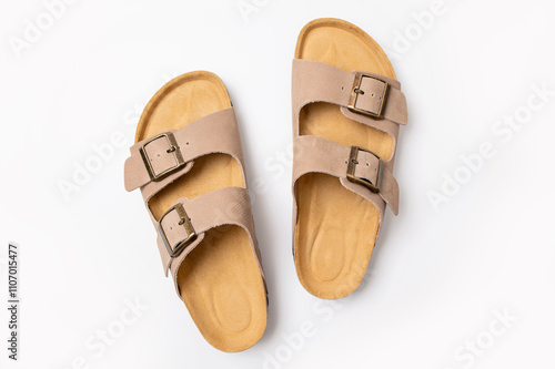 Leather beige sandals birkenstocks on white background top view flat lay. Unisex summer shoes, genuine leather flip flops with cork soles. Stylish fashion footwear, mockup for design