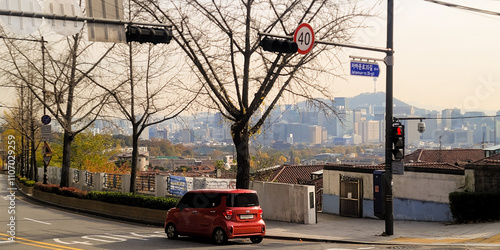 Photography Autumnal street view of Jongno with a cityscape in the background, in Seoul, Kor