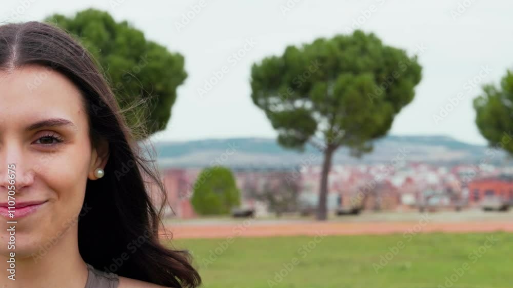 Woman slowly opening eyes and smiling in a park, copy space Woman slowly opening eyes and smiling in a park, copy space