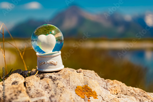 Crystal ball, with a heart inside, alpine summer landscape shot at Mount Penken, Mayrhofen, Finkenberg, Zillertal valley, Schwaz, Zell am Ziller, Tyrol, Austria photo