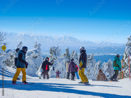 People going down in snow slope surrounded by ice monsters (Zao, Yamagata, Japan) photo