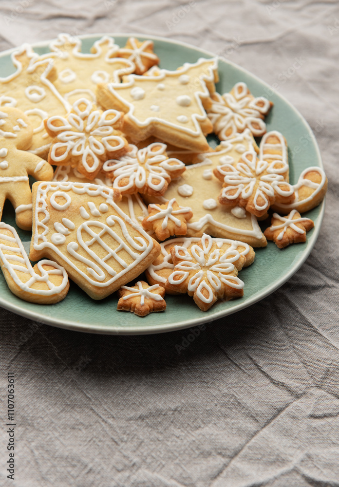 Christmas cookies with white icing forming various shapes lying on a plate Christmas cookies with white icing forming various shapes lying on a plate