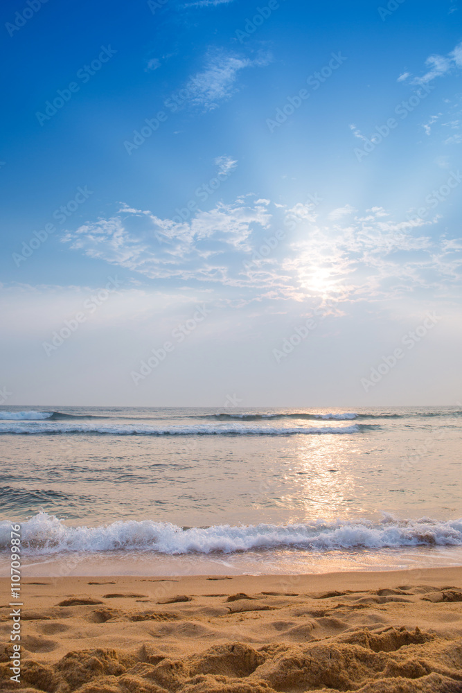 Fototapeta premium The beach by the ocean is empty and the sky is blue