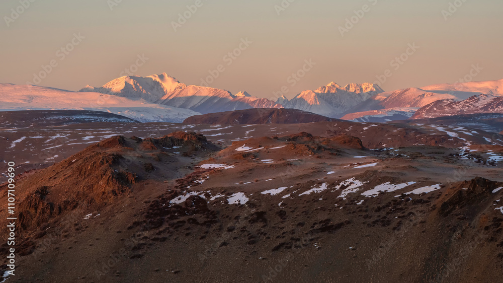 Snow on the peaks, deserted mountain slopes. Panoramic view. Snow on the peaks, deserted mountain slopes. Panoramic view.