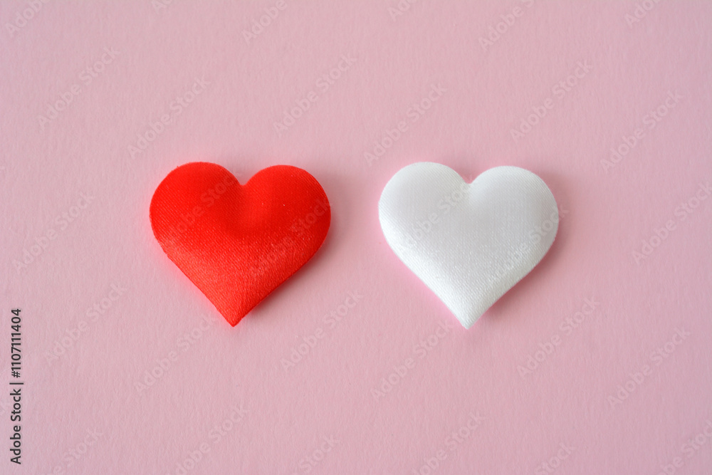 two red and white hearts are placed on a pink background top view two red and white hearts are placed on a pink background top view