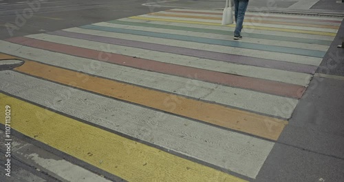 Wallpaper Mural Close up of a colorful striped pedestrian crossing in Graz, Austria, with a person walking across Torontodigital.ca