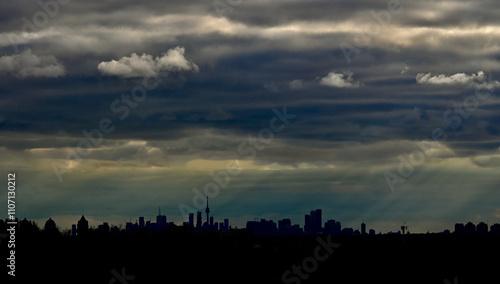 Photography A sky covered with dark clouds but with a hint of sunshine, paired with the silh