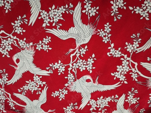 White cranes on red fabric 