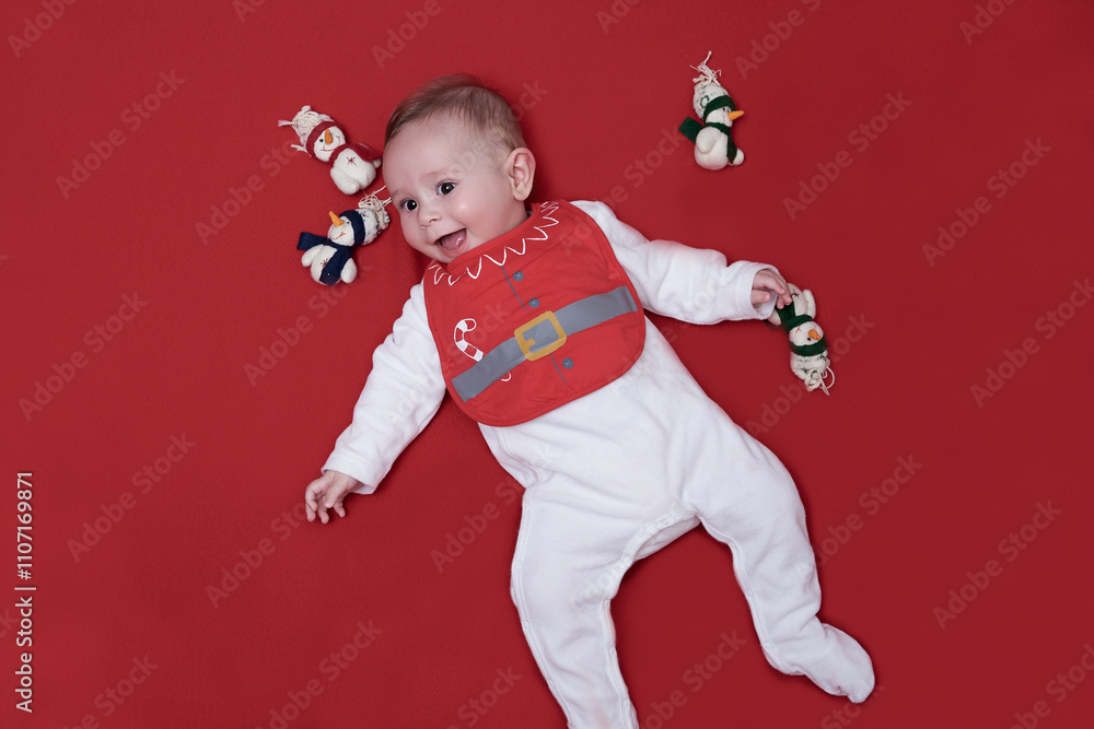Adorable baby in Christmas bib smiling away. Adorable baby in Christmas bib smiling away.