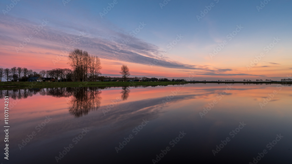 Winter sunset panoramic sky landscape with reflections in water - Hunzedal, Drenthe, The Netherlands. Winter sunset panoramic sky landscape with reflections in water - Hunzedal, Drenthe, The Netherlands.