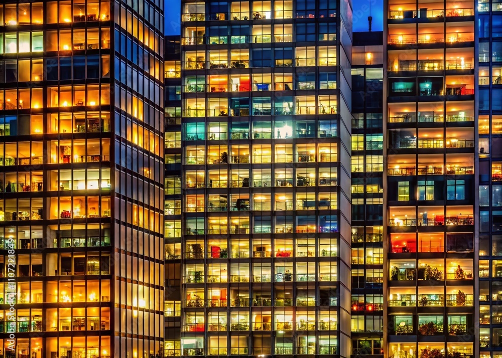 Vibrant Nighttime View of a Tall Building with Illuminated Windows, Capturing the Lively Atmosphere of City Life and Architectural Beauty Against a Dark Sky Vibrant Nighttime View of a Tall Building with Illuminated Windows, Capturing the Lively Atmosphere of City Life and Architectural Beauty Against a Dark Sky