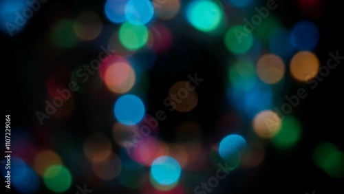 Blurred rainbow colored lens flare motion studio lightning, garland with bokeh effect on black background. Light leaks shining, abstract background footage.