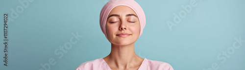 Surgery eyelid rejuvenation concept. A serene woman with closed eyes, wearing a pink headscarf, embodies tranquility and self-care against a pastel blue background. photo