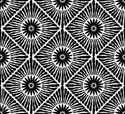 Seamless boho inspired pattern with vibrant floral sunburst designs arranged in a diamond layout.
