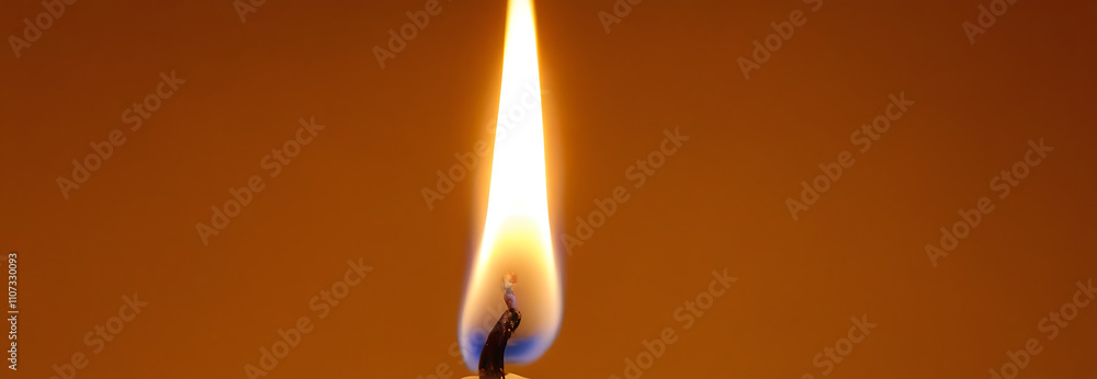 A single flame of a candle in a dark environment. A single flame of a candle in a dark environment.