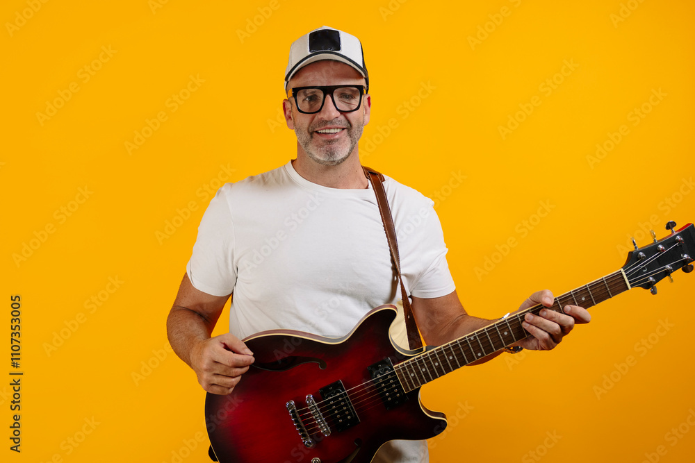 Obraz premium Adult man with his red electric guitar.