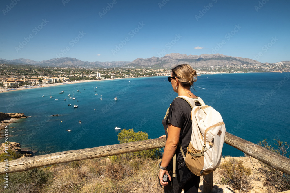 Fototapeta premium Girl with backpack looking at the sea